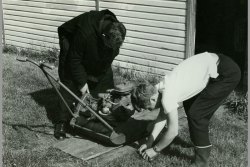 [333] 1966 Fr Bernard checks mower repair